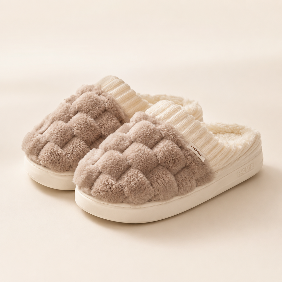Pair of Warm Taupe Elowen woven-plush house slippers with ivory ribbed collars and HOME labels.