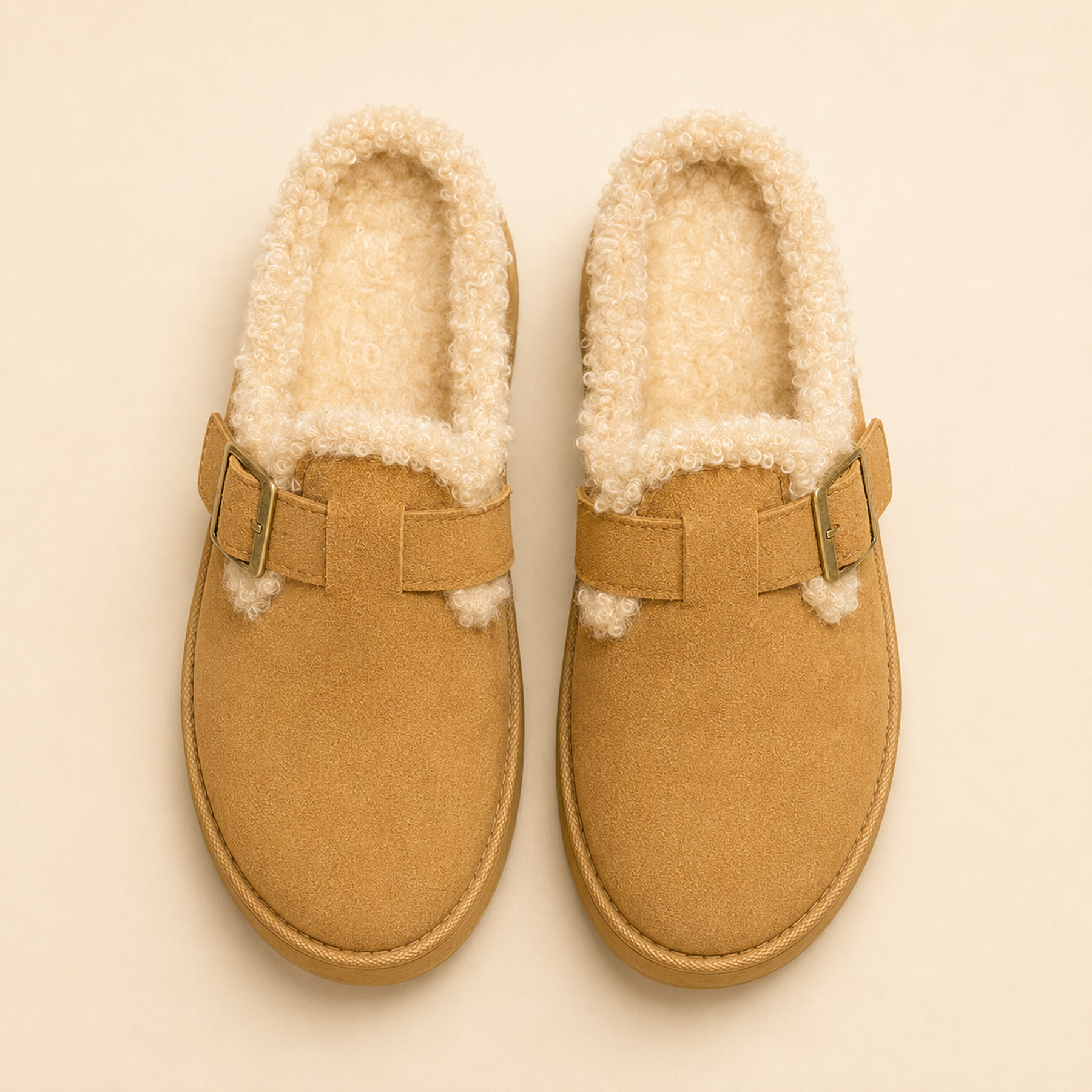 Overhead view of Camel Aurelia clogs showing the rounded toes, outer-side buckles and plush faux-fur footbeds.