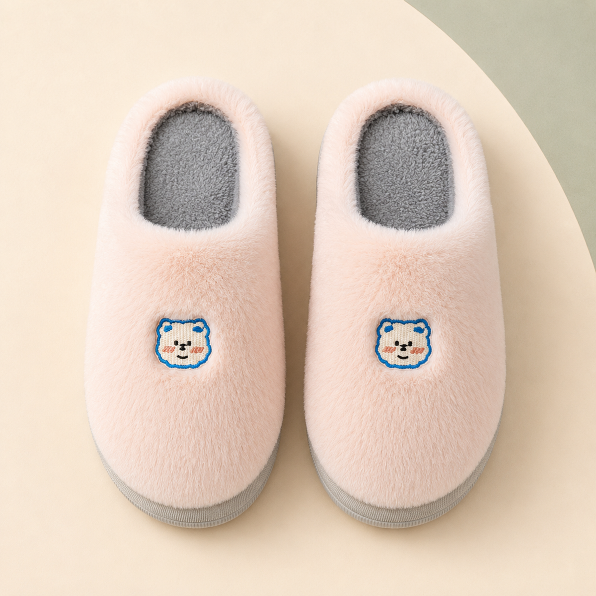 Overhead view of Blush Lumi slippers showing the rounded plush uppers, bear embroidery and grey cotton footbeds.