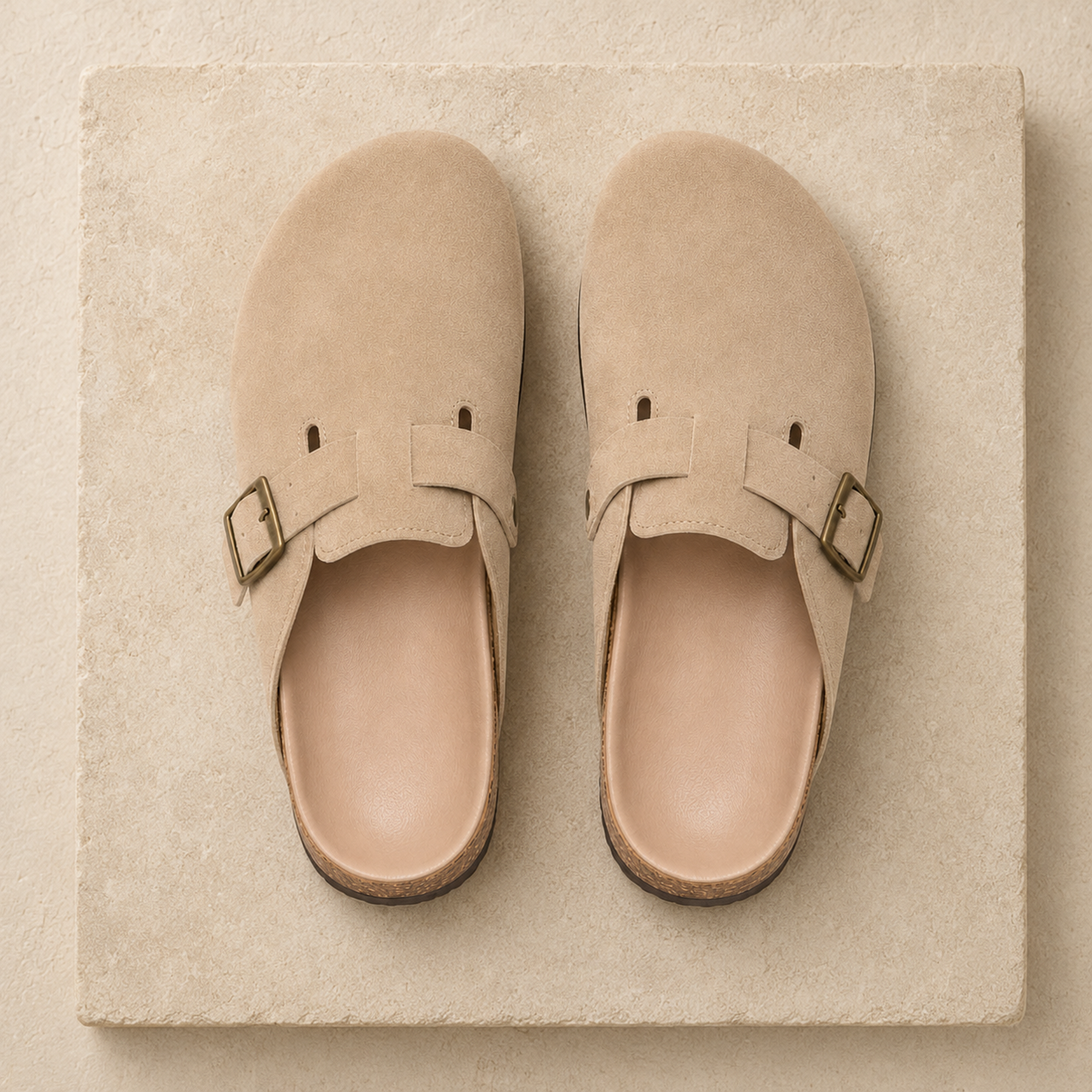 Top view of beige Marlow suede buckle clogs showing the leather footbeds and buckle straps.