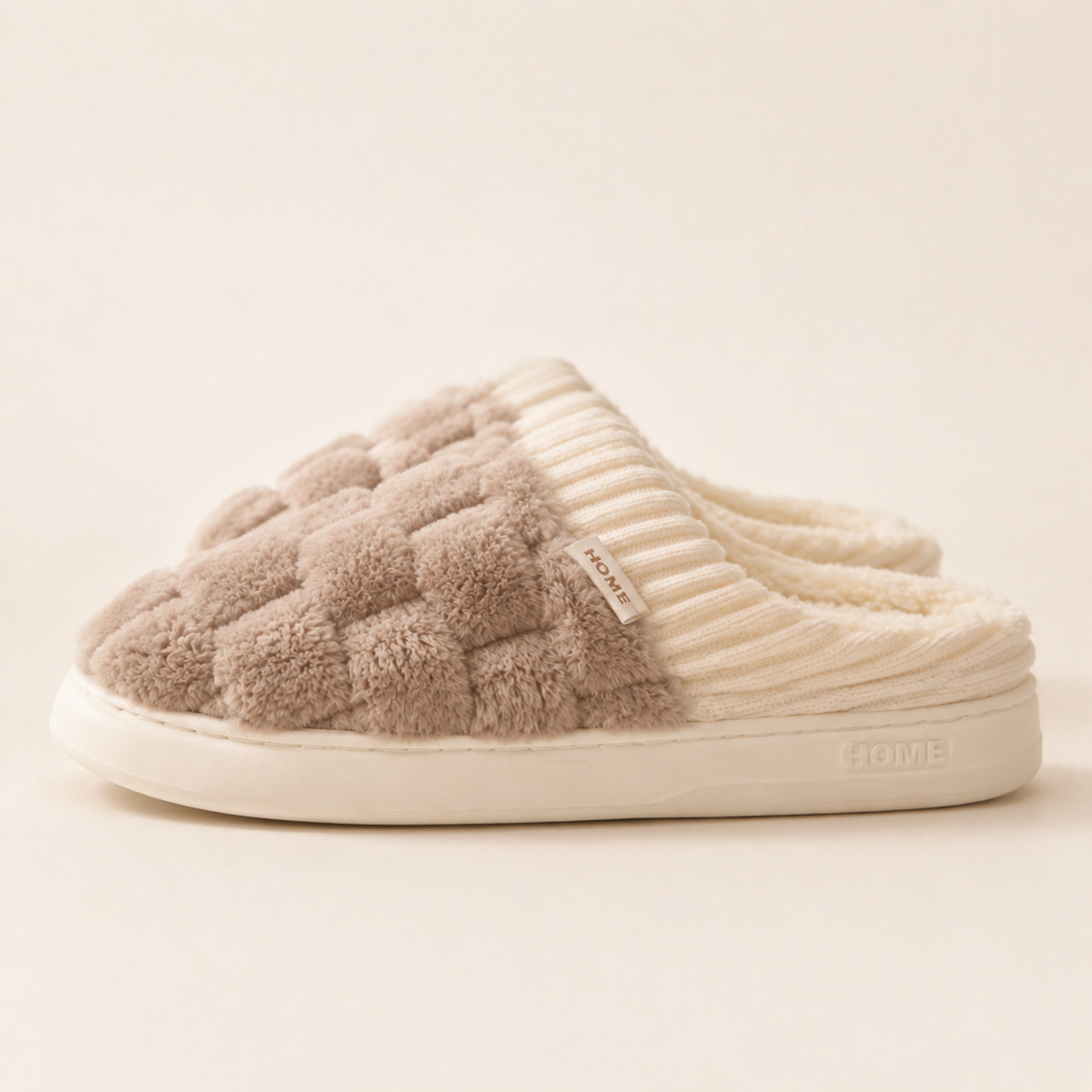Side profile of a Warm Taupe Elowen slipper showing its open back, ribbed collar, HOME label and PVC outsole.