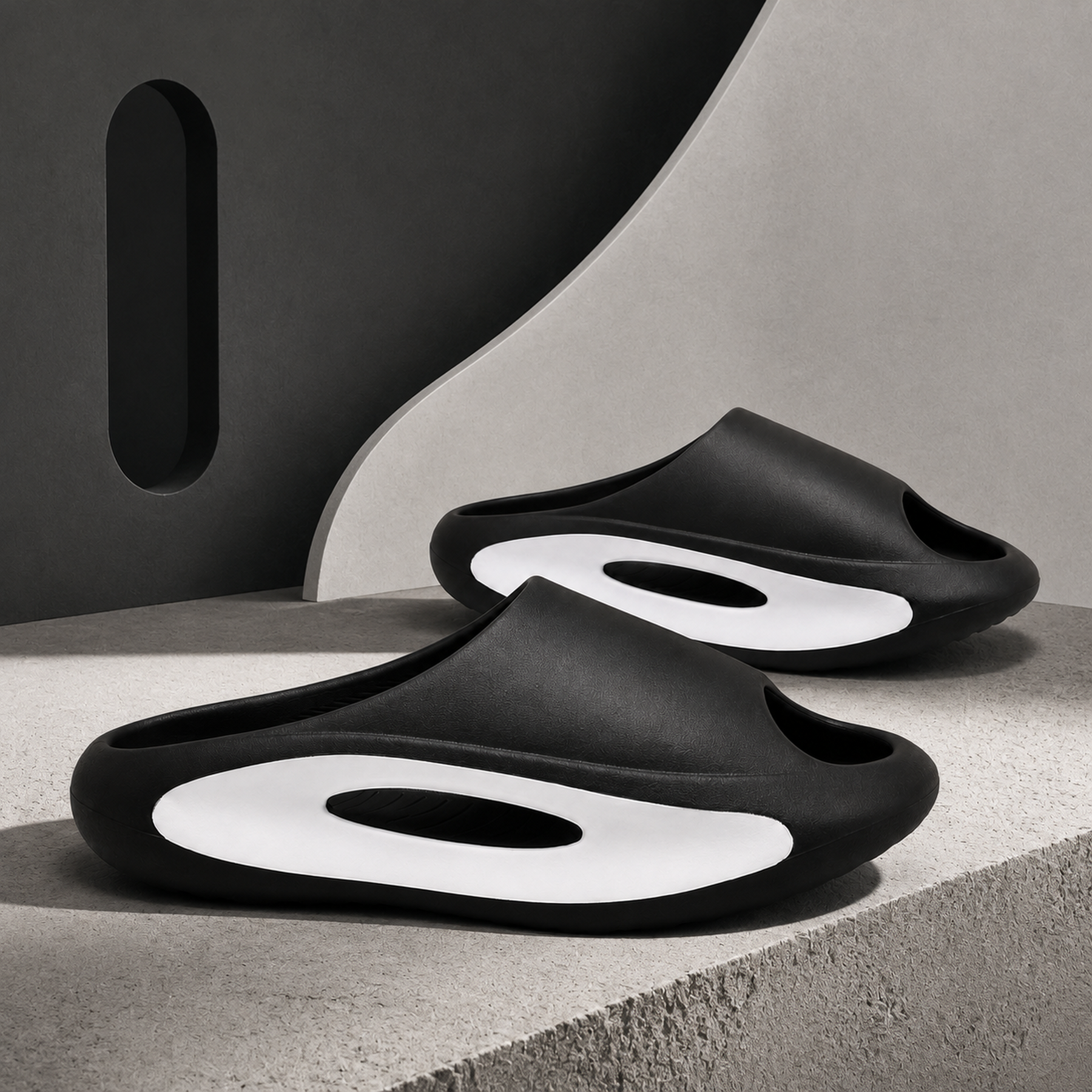 Side profile of black Soren EVA slides showing the white recessed insert and oval side window.