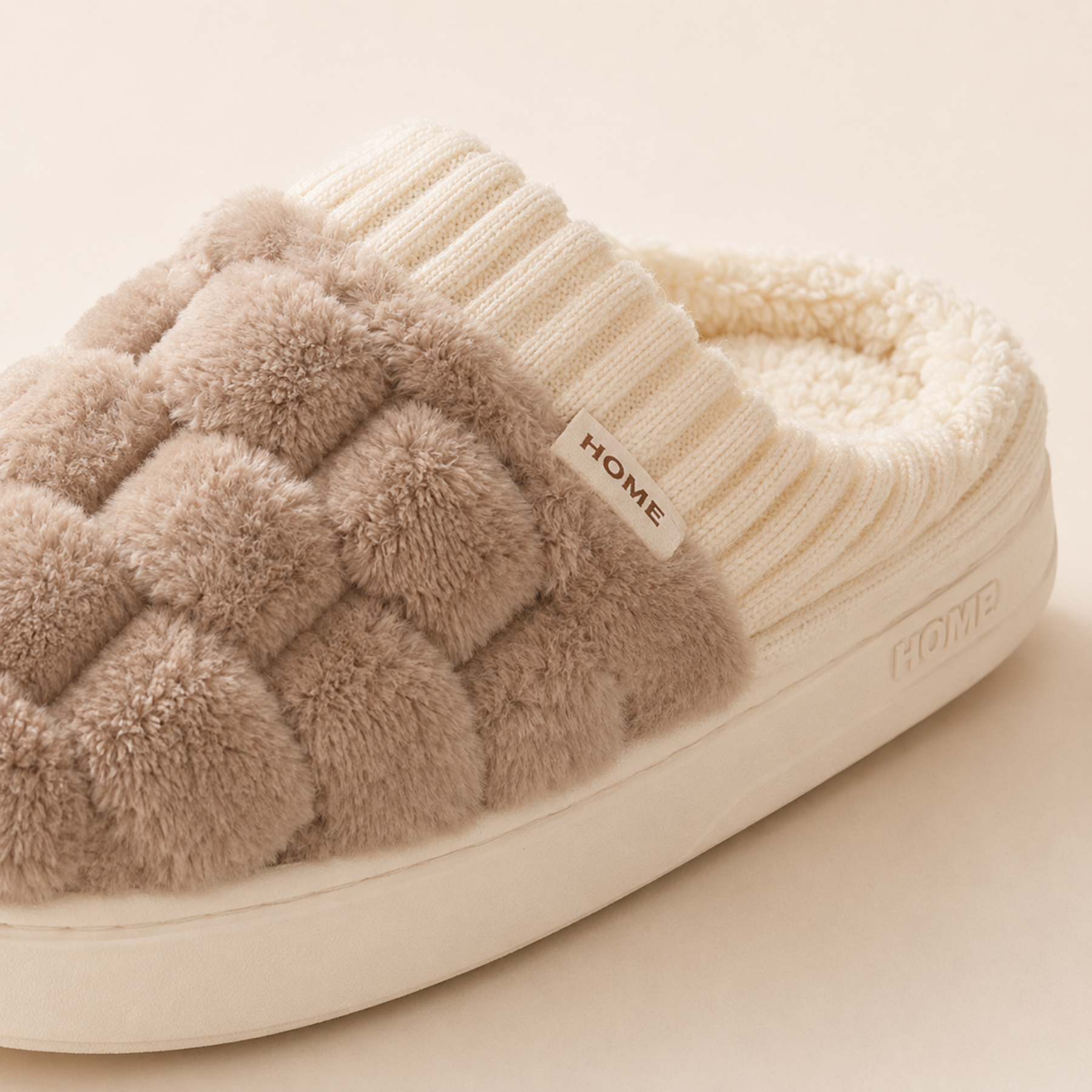 Close view of the Elowen woven-plush upper, artificial-wool interior, HOME label and ivory PVC outsole.
