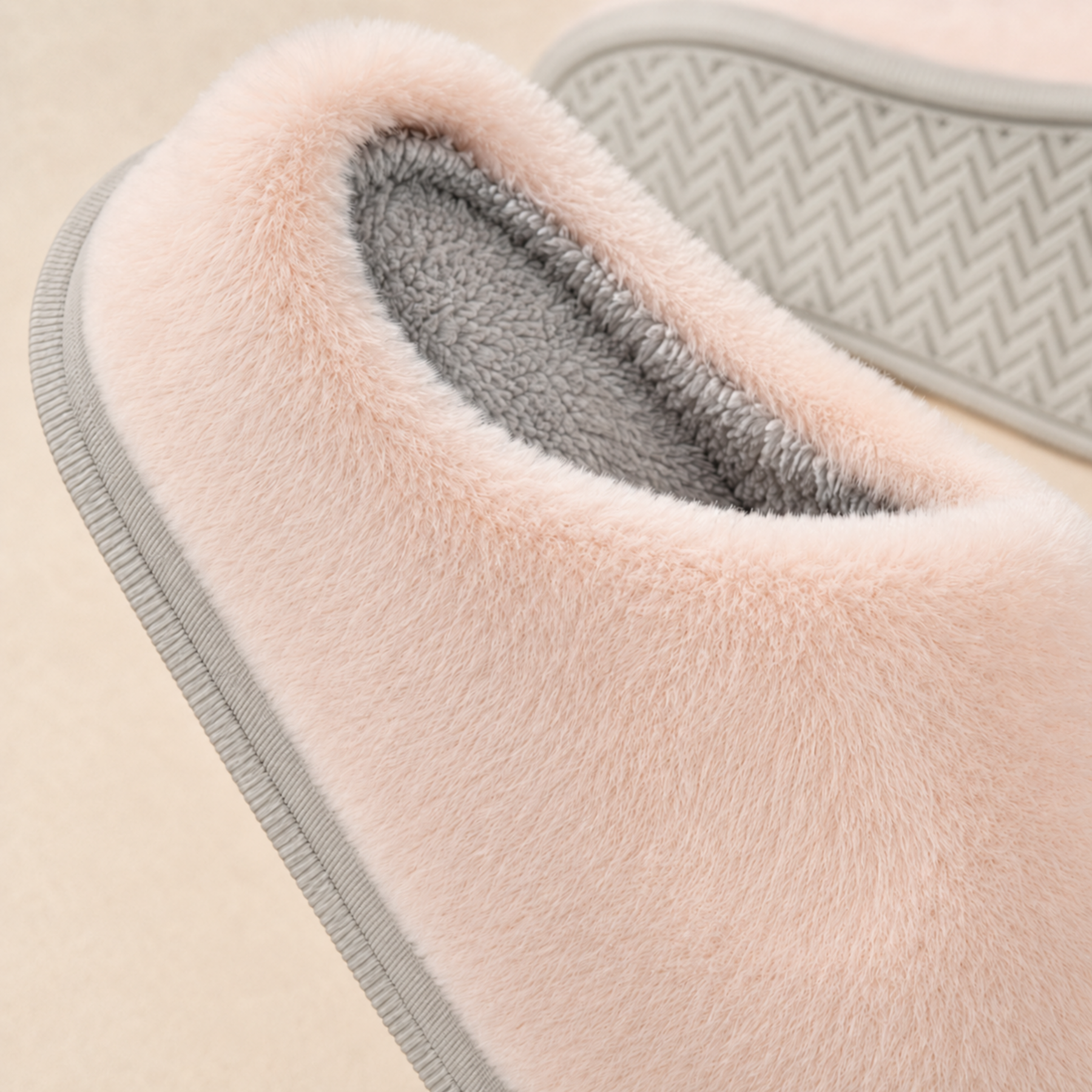 Close view of the Lumi cotton-fabric pile, grey cotton interior, embroidered bear face and PVC outsole pattern.